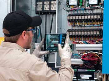Technician assessing HVAC equipment
